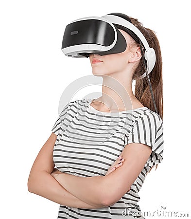 A young woman in virtual reality glasses enjoys his trip in an adventurous world, isolated on white background. Digital VR device. Stock Photo