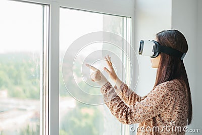 Young woman with virtual reality glasses. Modern technologies. The concept of future technology. Stock Photo