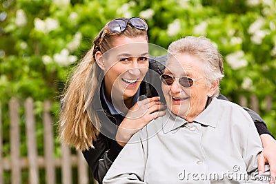 Young woman is visiting her grandmother in nursing home Stock Photo