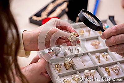 Young woman visiting old male jeweler Stock Photo