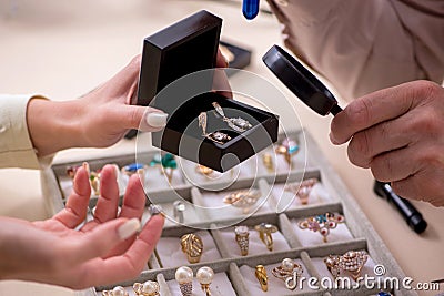 Young woman visiting old male jeweler Stock Photo