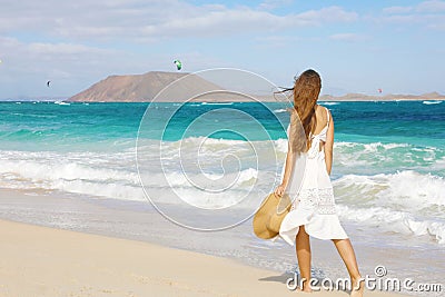 Young woman walking on Corralejo wild beach looking at Lobos Island on the background, Fuerteventura, Canary Islands Stock Photo