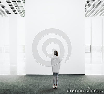 Young woman walking through a gallery and looking Stock Photo