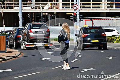 Young woman walks in the middle of the road Editorial Stock Photo