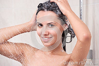 Young woman washing head by shampoo Stock Photo