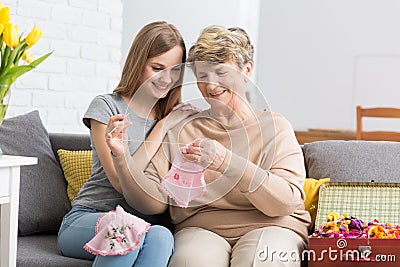 Young woman watching her grandma embroider Stock Photo