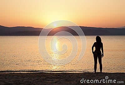 Young woman watching sunset Stock Photo