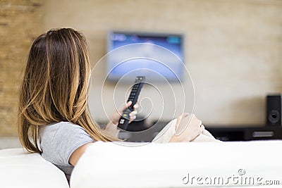 Young woman watching TV Stock Photo