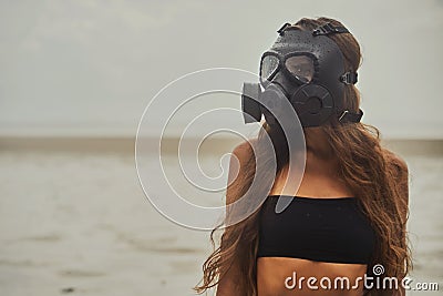 Young woman is wearing a gas mask Stock Photo