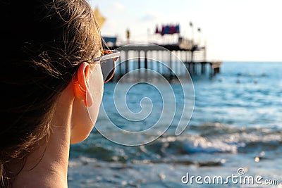 Young woman wearing glasses looking at sea Editorial Stock Photo