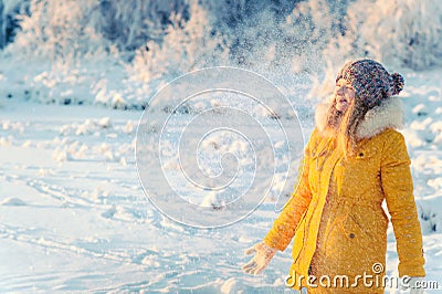 Young Woman wearing gloves playing with snow outdoor Winter vacations Stock Photo