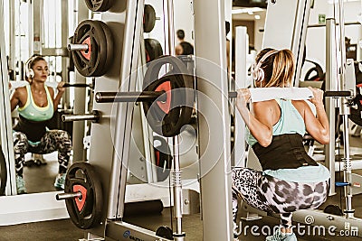 Woman lifting weights behind head Editorial Stock Photo