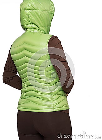 Young woman wearing light green hooded packable down puffer vest Stock Photo