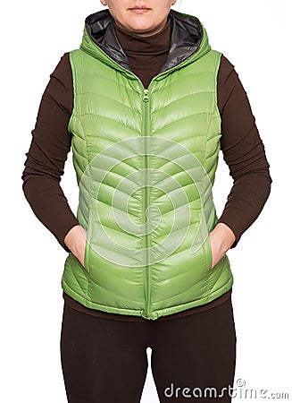 Young woman wearing light green hooded packable down puffer vest Stock Photo