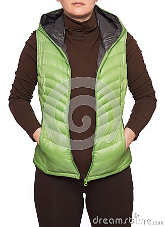 Young woman wearing light green hooded packable down puffer vest Stock Photo