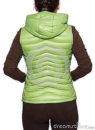 Young woman wearing light green hooded packable down puffer vest Stock Photo