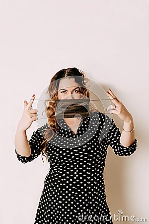 Young woman wearing medical face mask, studio portrait. Woman wearing surgical mask for corona virus Stock Photo