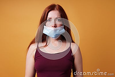 Young woman wearing medical face mask wrong leaving nose uncovered Stock Photo