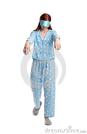 Young woman wearing pajamas, mask and slippers in sleepwalking state on white background Stock Photo