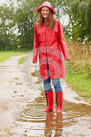 https://thumbs.dreamstime.com/x/young-woman-wearing-raincoat-playing-puddle-10790255.jpg
