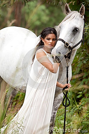 Young Woman with White Horse Stock Photo