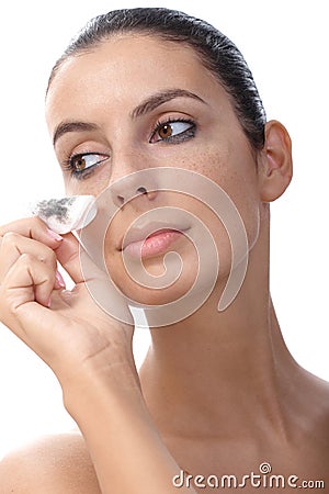 Young woman wiping away makeup Stock Photo