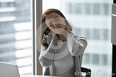Young woman worker suffer from neck ache or spasm Stock Photo