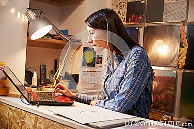 Young woman working behind the counter at a record shop Stock Photo