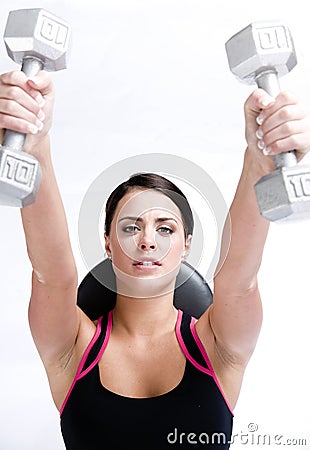 Young woman working out lifting barbells Stock Photo