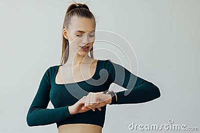 Young woman workout in gym using smart watch and application. Technology and sport concept Stock Photo