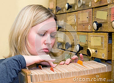 Young woman works with library card index Stock Photo