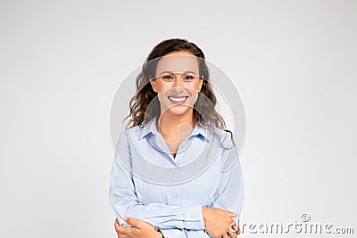 Young woman wraps her arms around herself, embodying insecurity and need for comfort Stock Photo