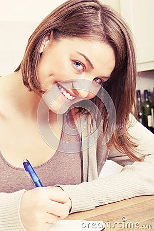 Young woman writes to black diary Stock Photo