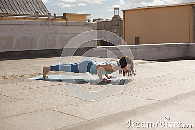 Young woman in a yoga four-limbed staff pose Stock Photo