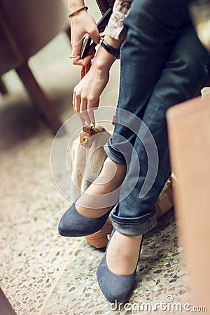 Young womans feet close up in a street cafe, urban mood Stock Photo