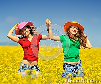 Young women on blooming field Stock Photo