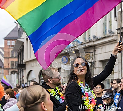 2019: Young women on a car and waving rainbow flags attending the Gay Pride parade also known as Christopher Street Day,Munich Editorial Stock Photo