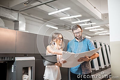 Woman with print operator at the manufacturing Stock Photo