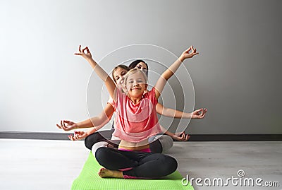 Young woman having fun with kids doing yoga Stock Photo