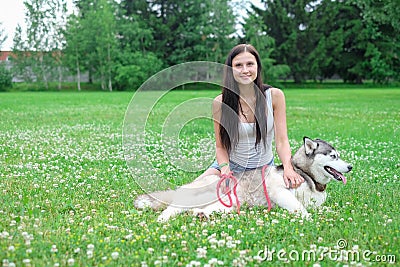 Young women and her dog husky resting near lake in summer Stock Photo