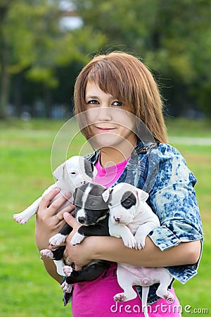 Young Women Holding Three Puppies Stock Photo