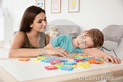 Young woman and little boy with autistic disorder playing Stock Photo