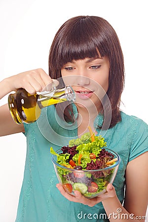 Young women making salad on white background Stock Photo