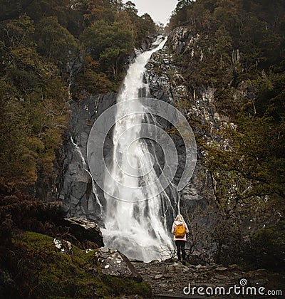Young Women with orange backpack exploring Aber waterfalls Editorial Stock Photo