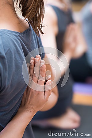 Women practicing yoga: reverse prayer pose Stock Photo