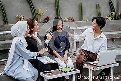 young woman is sad and comforted by friends while sitting together Stock Photo