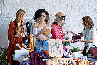 Young women at swap party. Casual clothes, shoes, hats, bags, jewellery Stock Photo