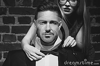 Woman tie bow for sexy man in tuxedo black and white Stock Photo