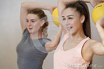 Young women training with medicine balls in fitness class Stock Photo
