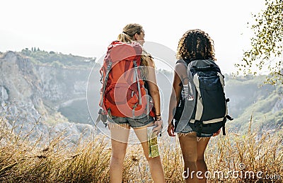 Young women traveling together into mountains Stock Photo